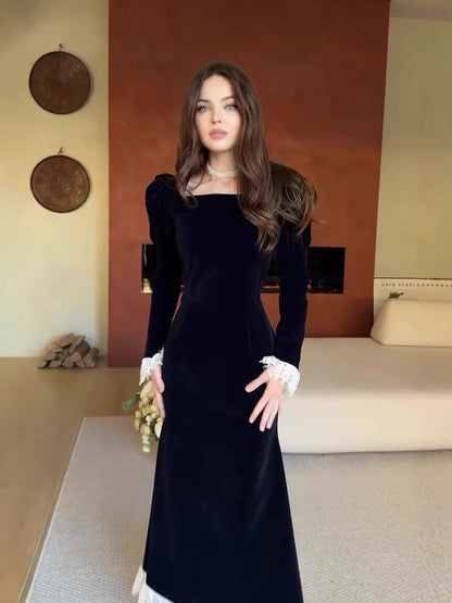 black long-sleeved waist-cinching dress